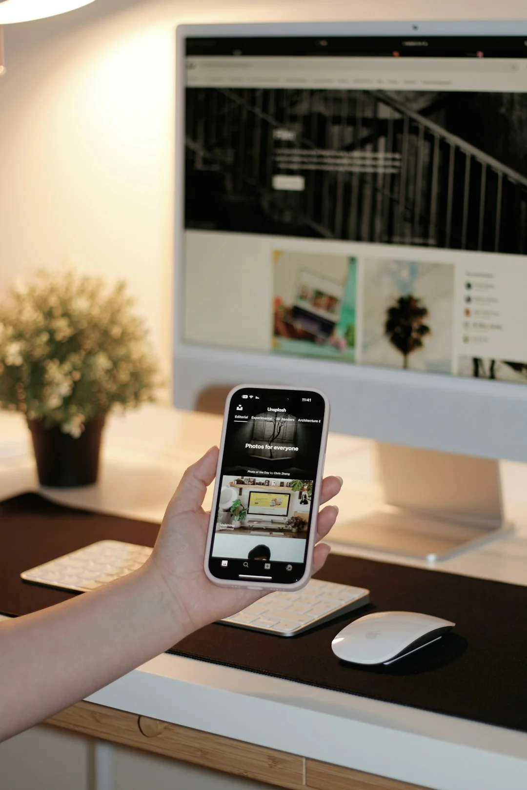 A sleek office desk setup featuring Apple devices: iMac, MacBook, and iPad.